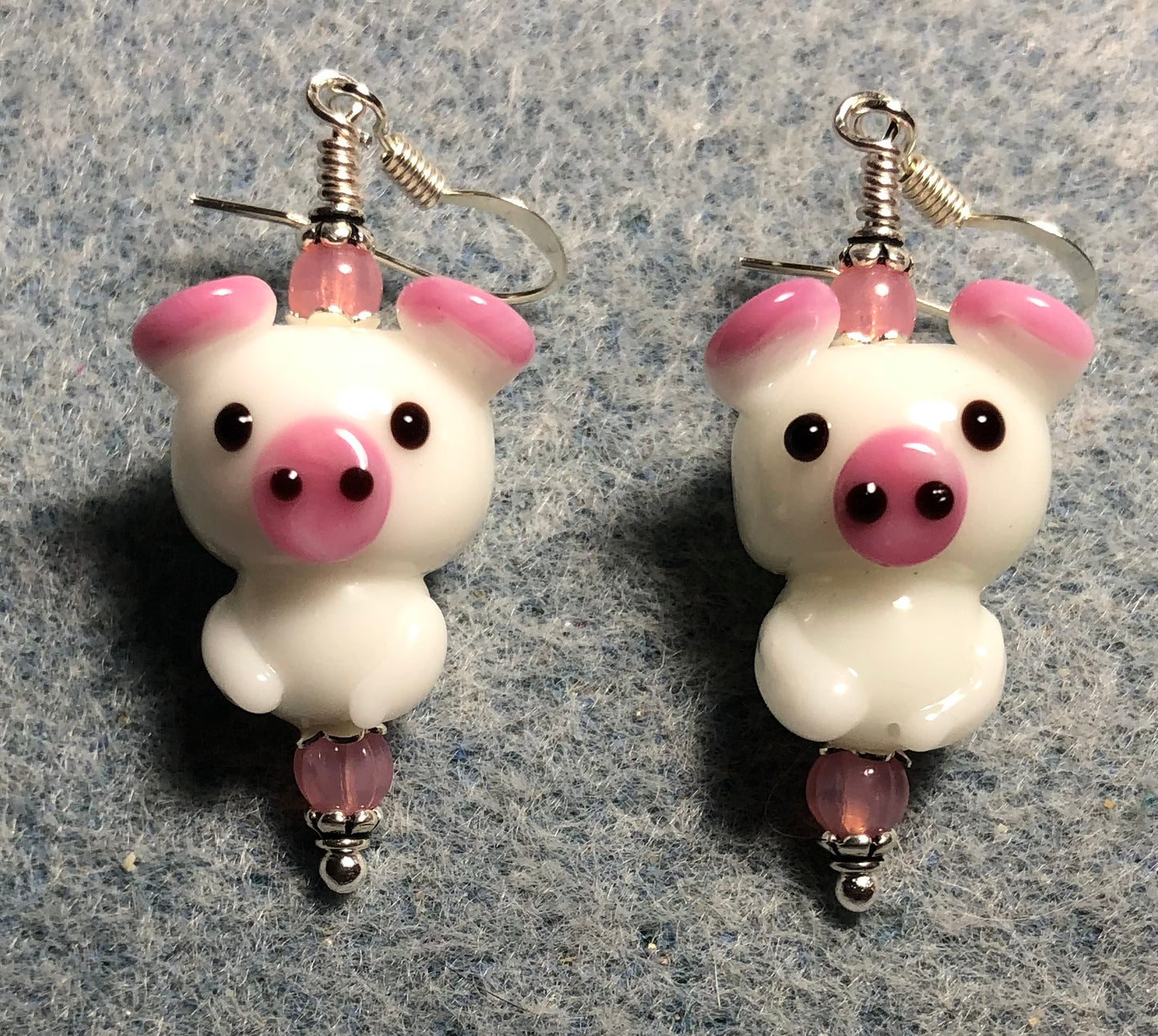 White and pink lamp work standing pig bead earrings adorned with pink Czech glass beads.