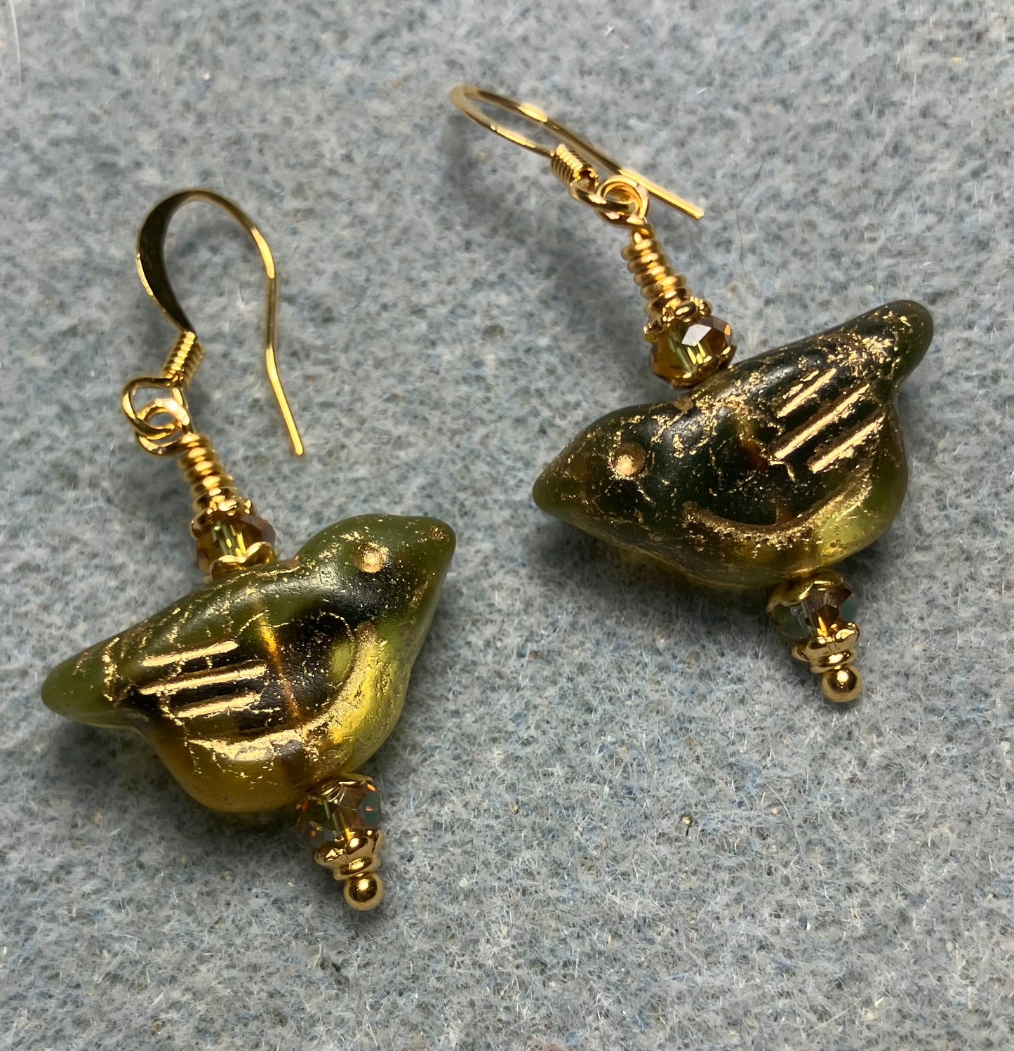 Olive green (with gold wash) Czech glass bird bead earrings adorned with sparkly olive green Chinese crystal beads.