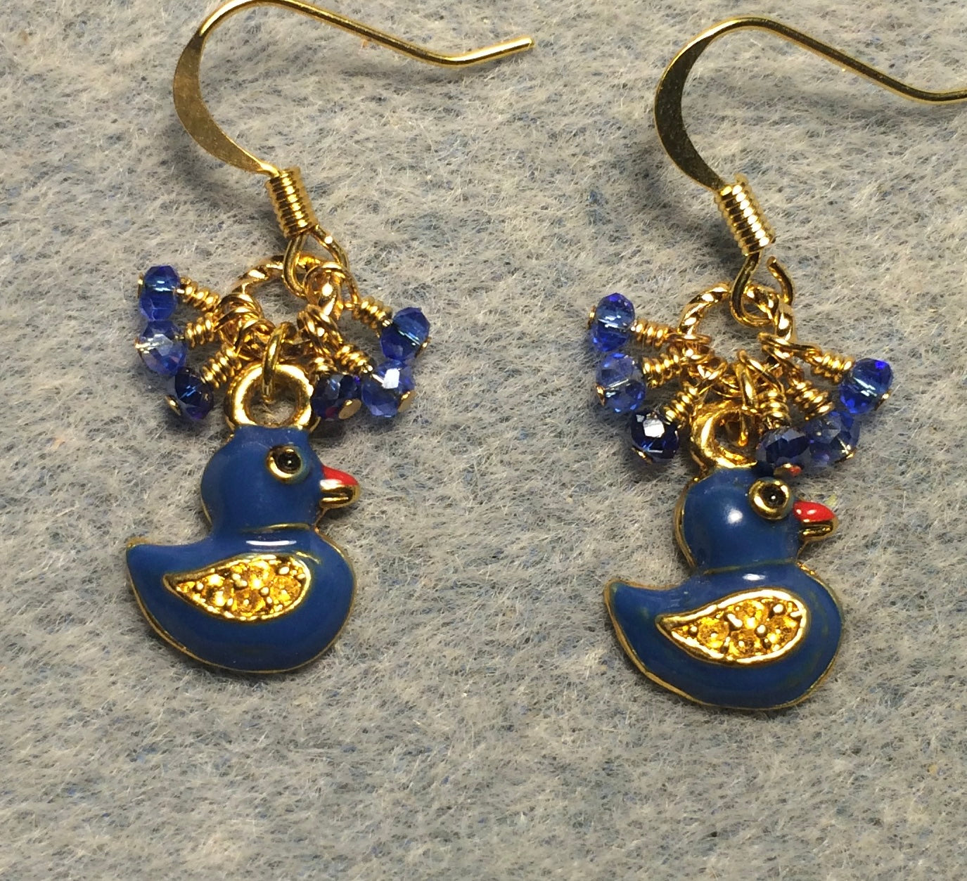 Small blue enamel duck charm earrings adorned with tiny dangling blue Chinese crystal beads.