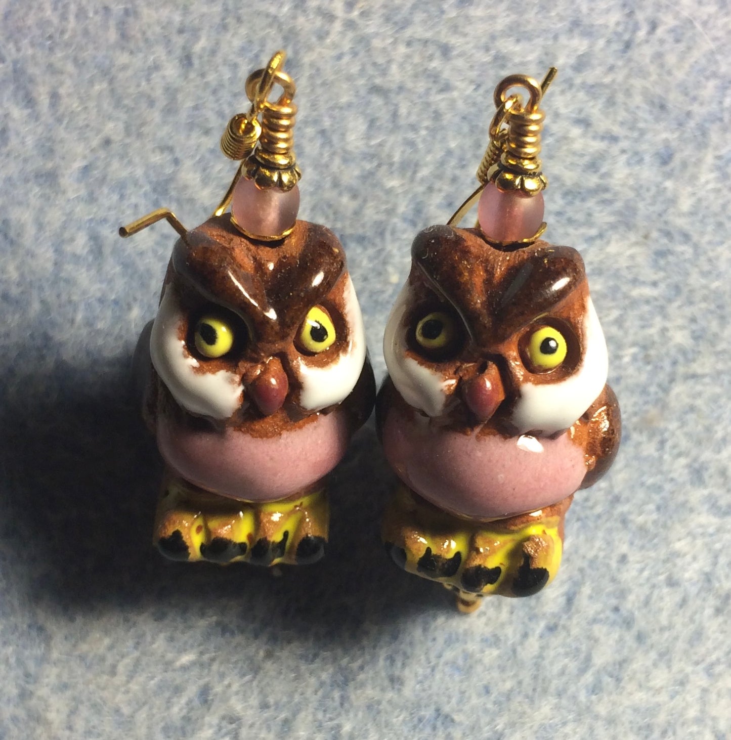 Large brown, light pink, and amber ceramic owl bead earrings adorned with light pink Czech glass beads.