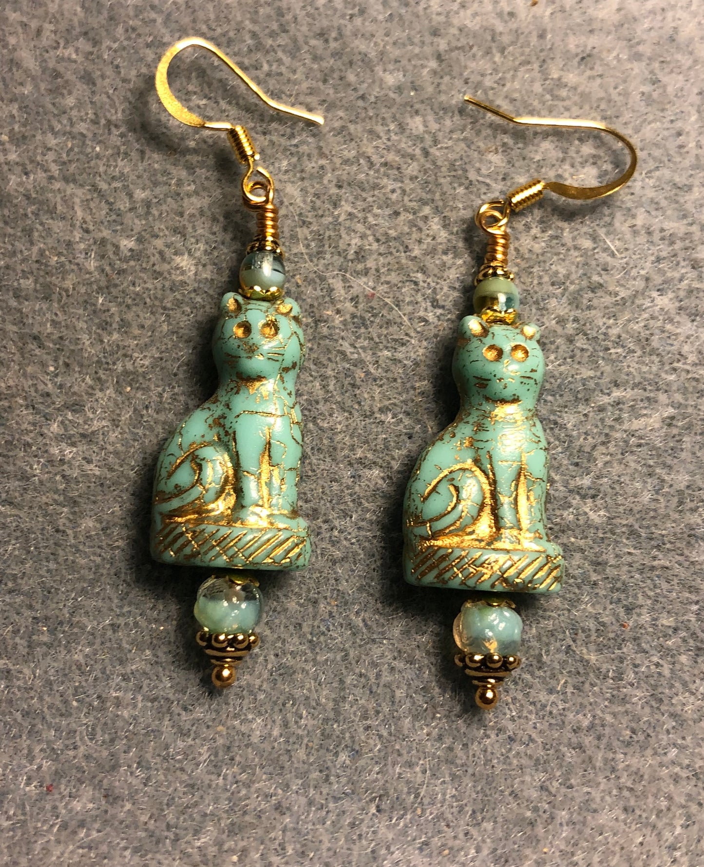 Opaque light turquoise (with gold inlay) fancy Czech glass cat bead earrings adorned with light turquoise Czech glass beads.