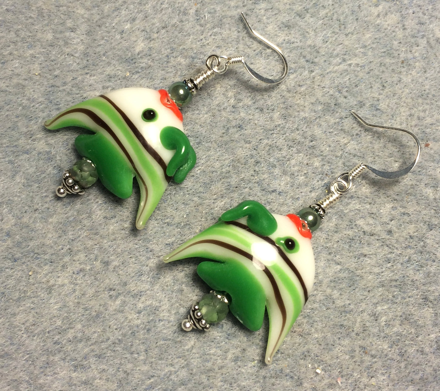 Green and white striped lamp work angelfish bead earrings adorned with green Czech glass beads.