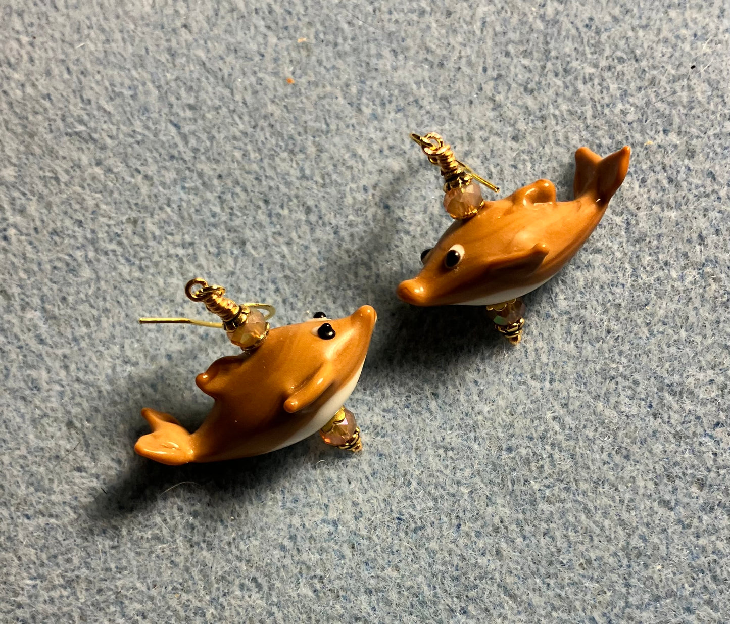 Tan lamp work whale bead earrings adorned with tan Chinese crystal beads.