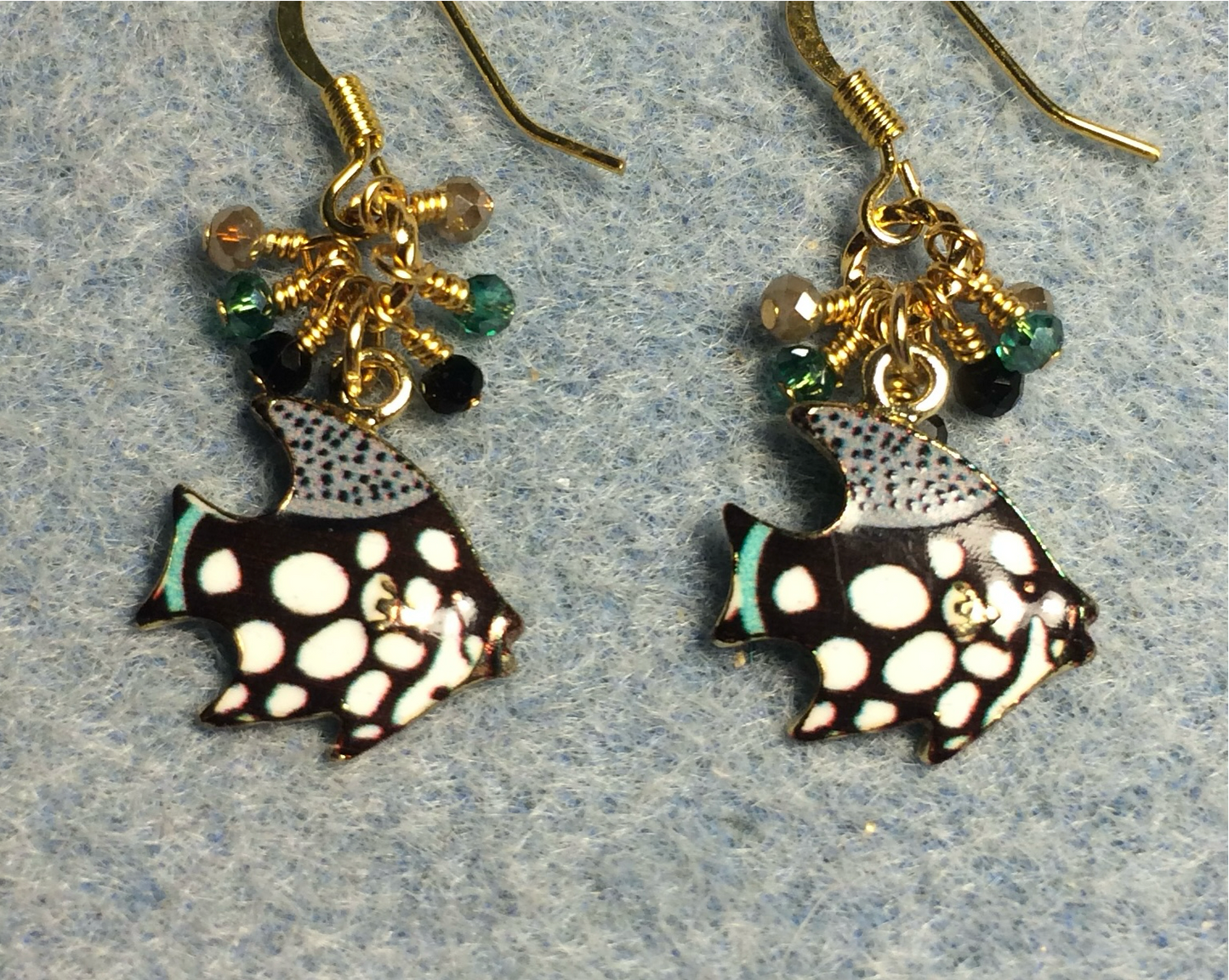 Black, teal, and white enamel spotted angelfish charm earrings adorned with tiny dangling black, teal, and white Chinese crystal beads.