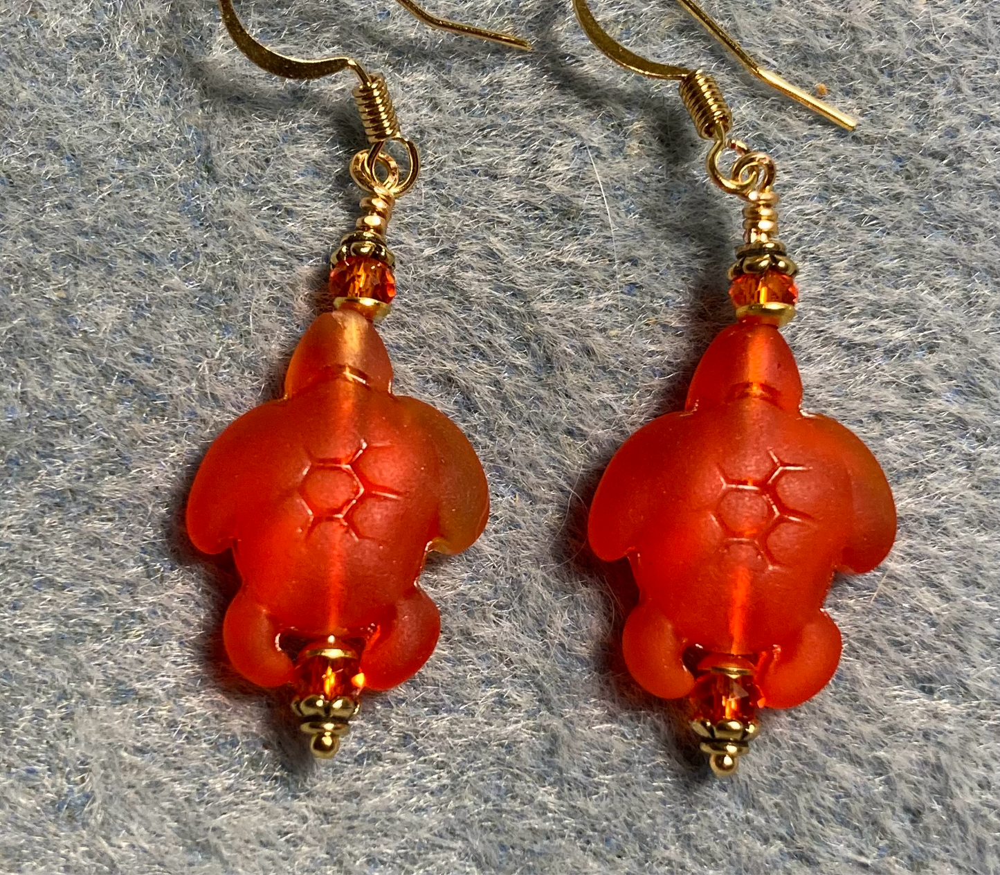 Orange red sea glass sea turtle bead earrings adorned with orange red Chinese crystal beads.