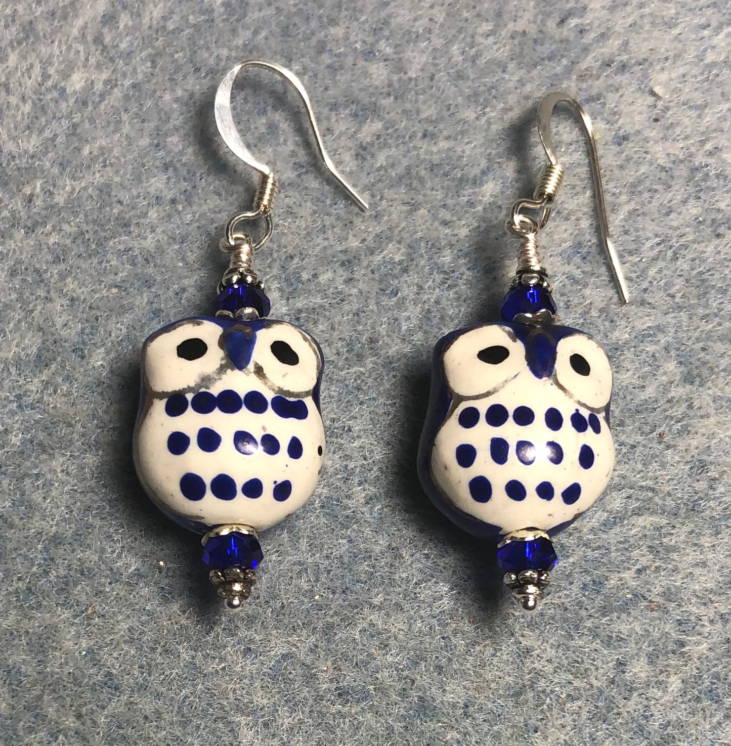 Dark blue ceramic spotted owl bead earrings adorned with dark blue Chinese crystal beads.