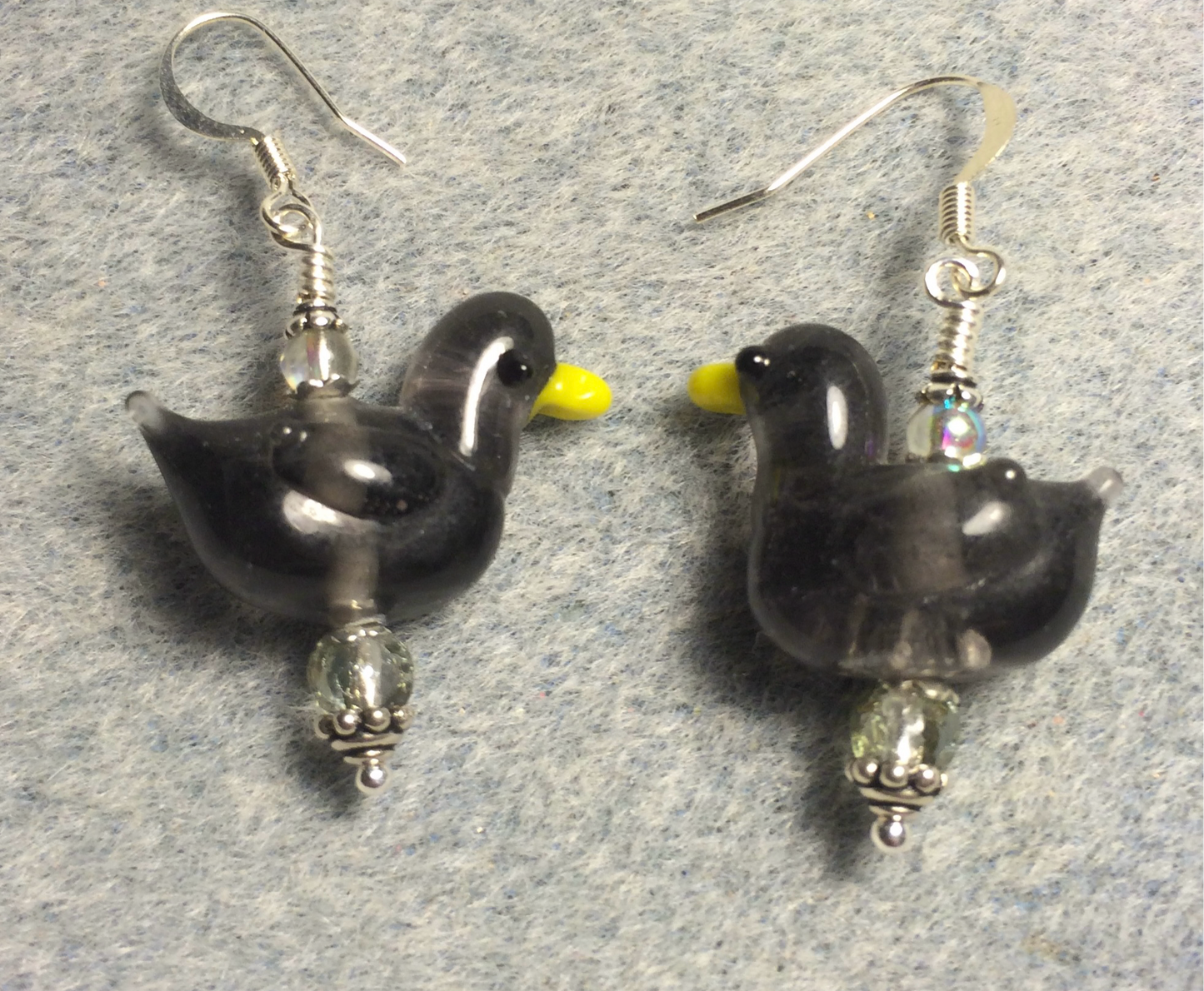 Translucent gray lamp work duck bead earrings adorned with clear gray Czech glass beads.
