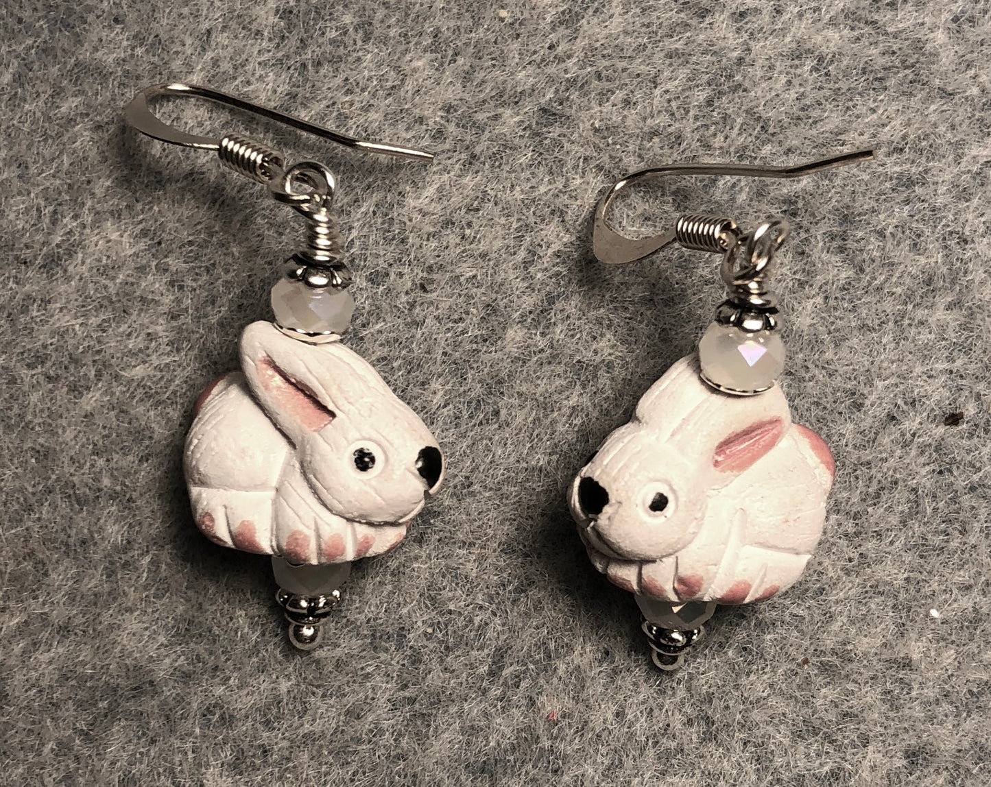 Small white and pink ceramic rabbit bead earrings adorned with white Chinese crystal beads.