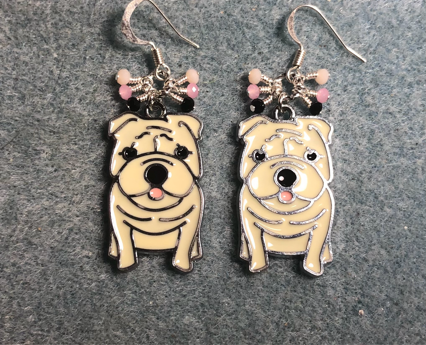 White, black, and pink enamel bulldog charm earrings adorned with tiny dangling white, black, and pink Chinese crystal beads.