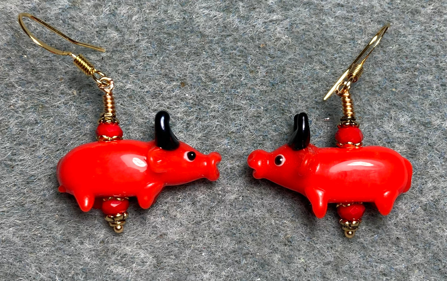 Red and black lamp work bull bead earrings adorned with red Chinese crystal beads.