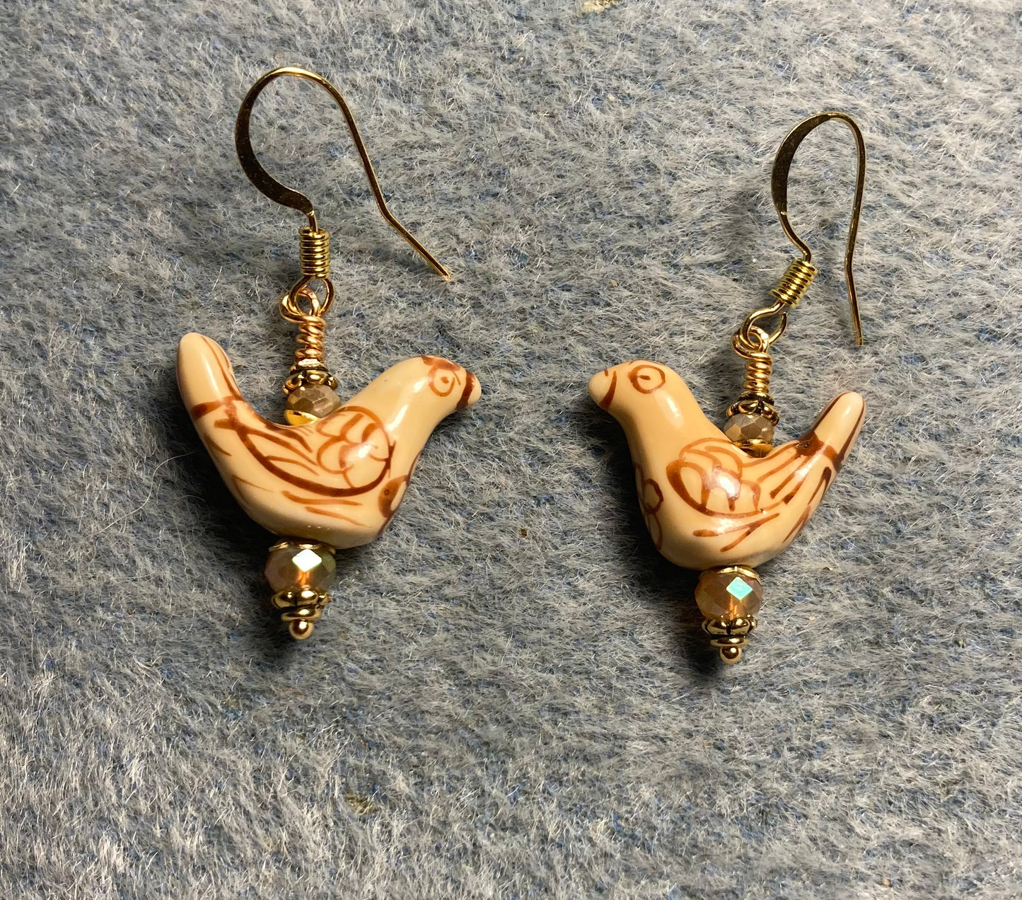Small tan ceramic bird bead earrings adorned with tan Chinese crystal beads.