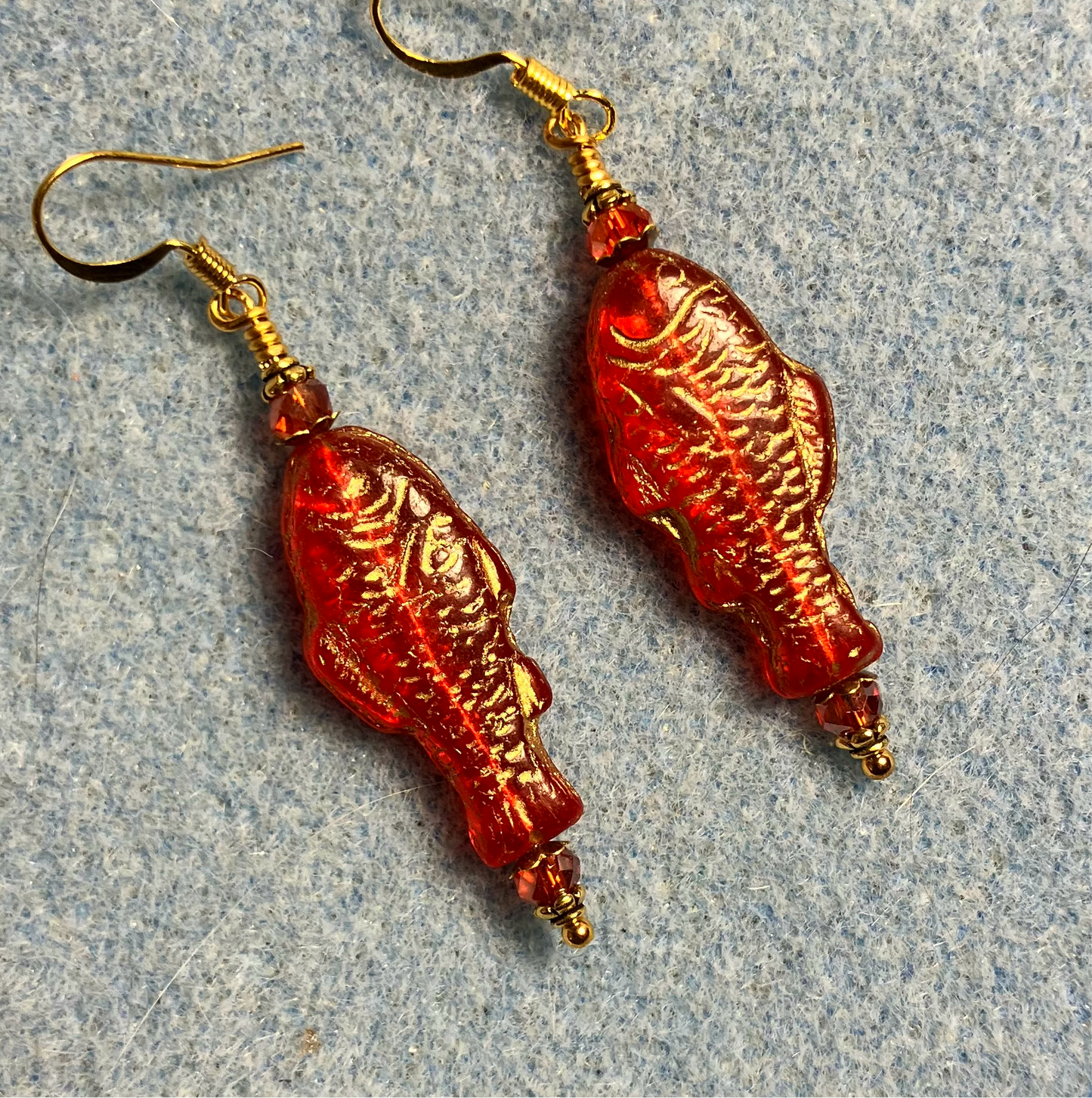 Bright red (with gold inlay) Czech glass fish bead earrings adorned with red Chinese crystal beads.