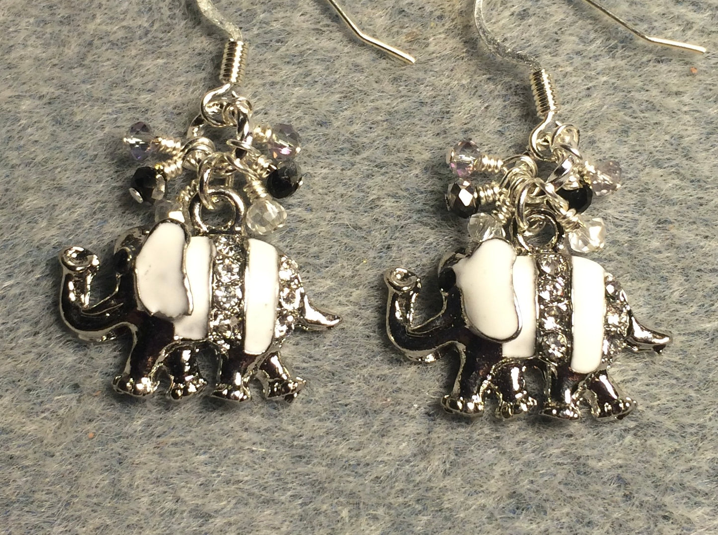Silver and white enamel and rhinestone elephant charm earrings adorned with tiny dangling gray and clear Chinese crystal beads.