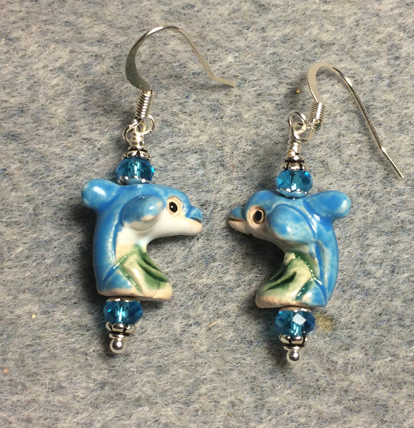 Small turquoise and green ceramic dolphin bead earrings adorned with turquoise Chinese crystal beads.