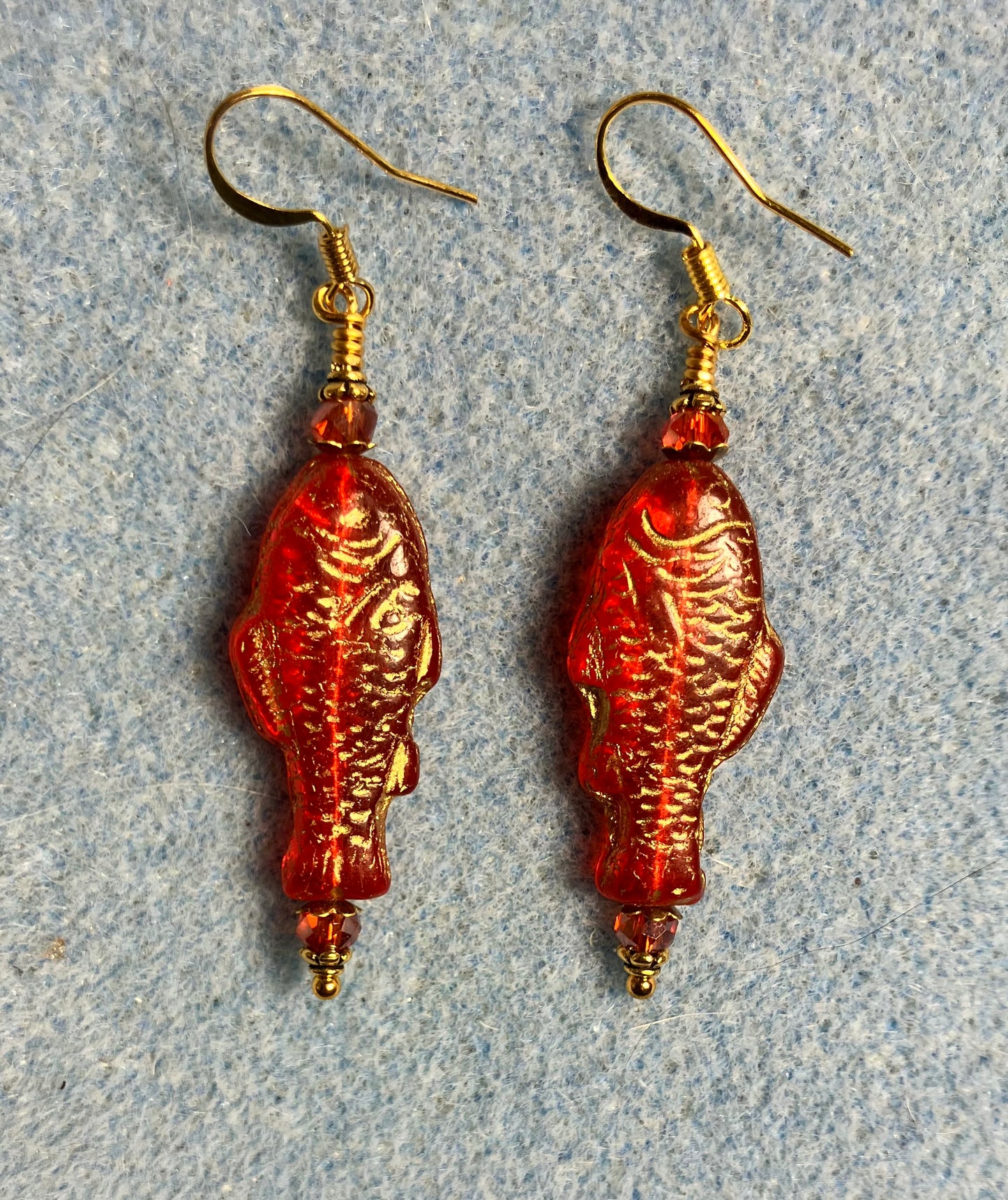 Bright red (with gold inlay) Czech glass fish bead earrings adorned with red Chinese crystal beads.