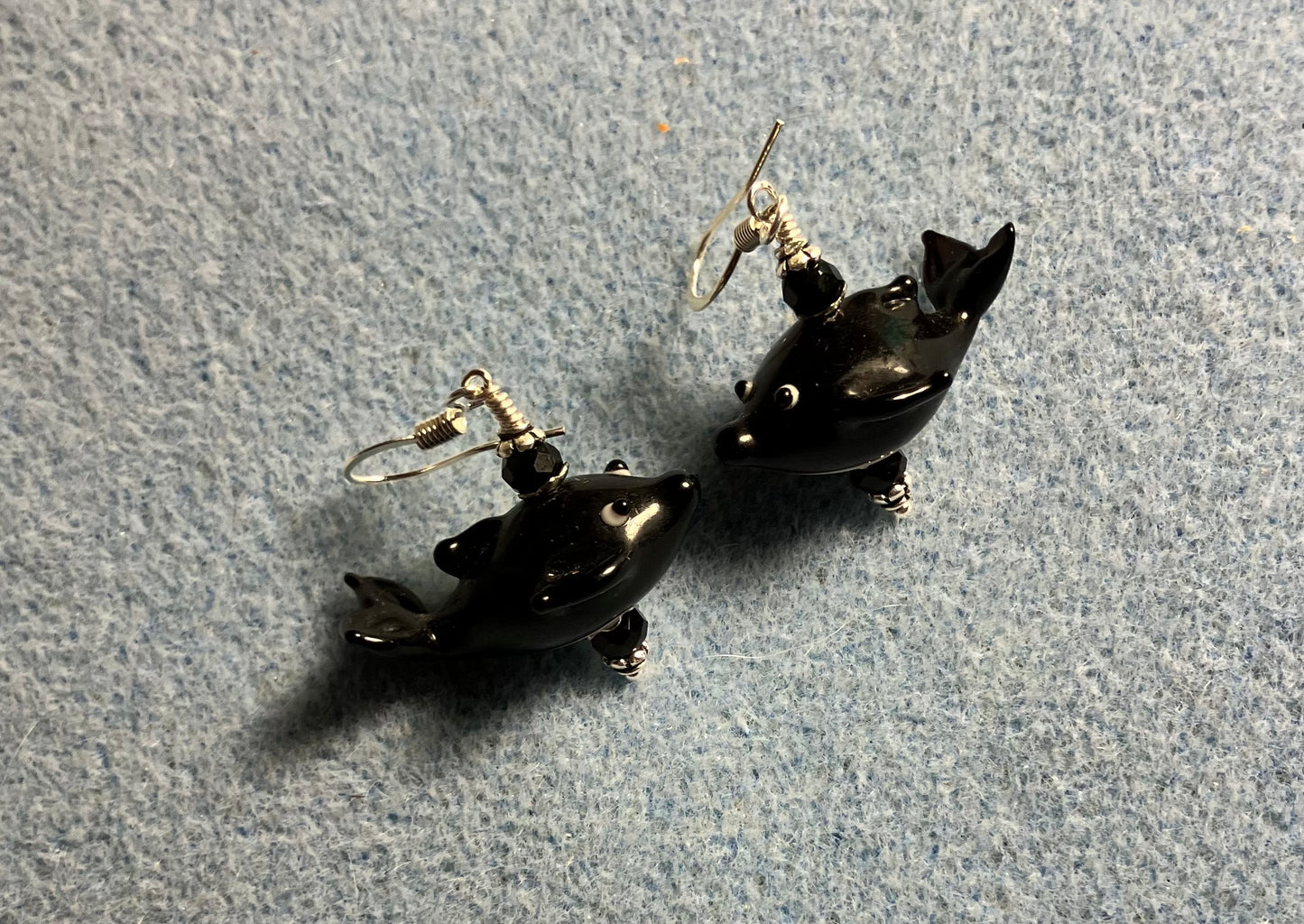 Black lamp work whale bead earrings adorned with black Chinese crystal beads.