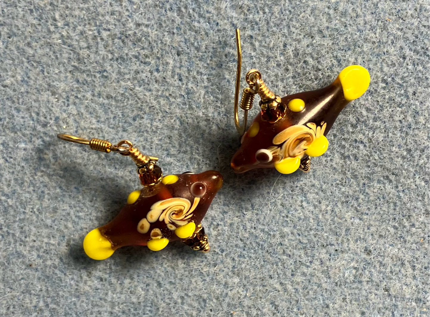 Amber lamp work fish bead earrings adorned with amber Chinese crystal beads.