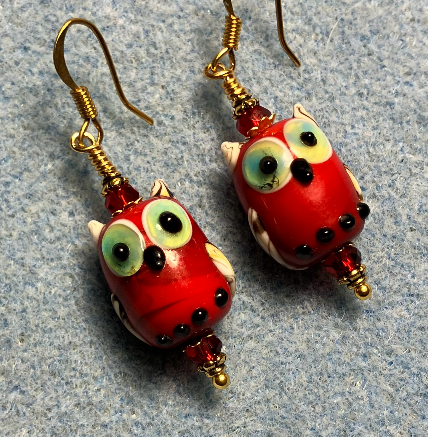 Red lamp work owl bead earrings adorned with red Chinese crystal beads.