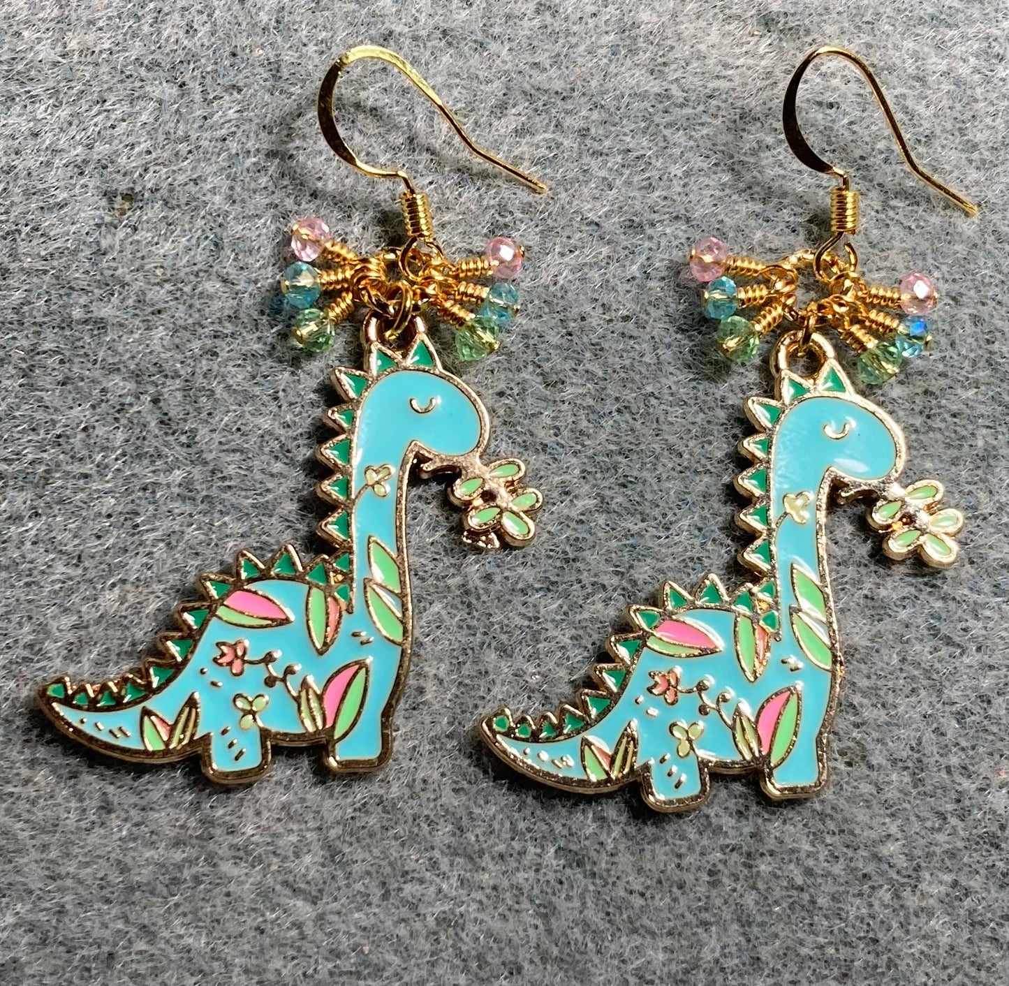 Turquoise, pink, and green enamel dinosaur charm earrings adorned with turquoise, pink, and green Chinese crystal beads