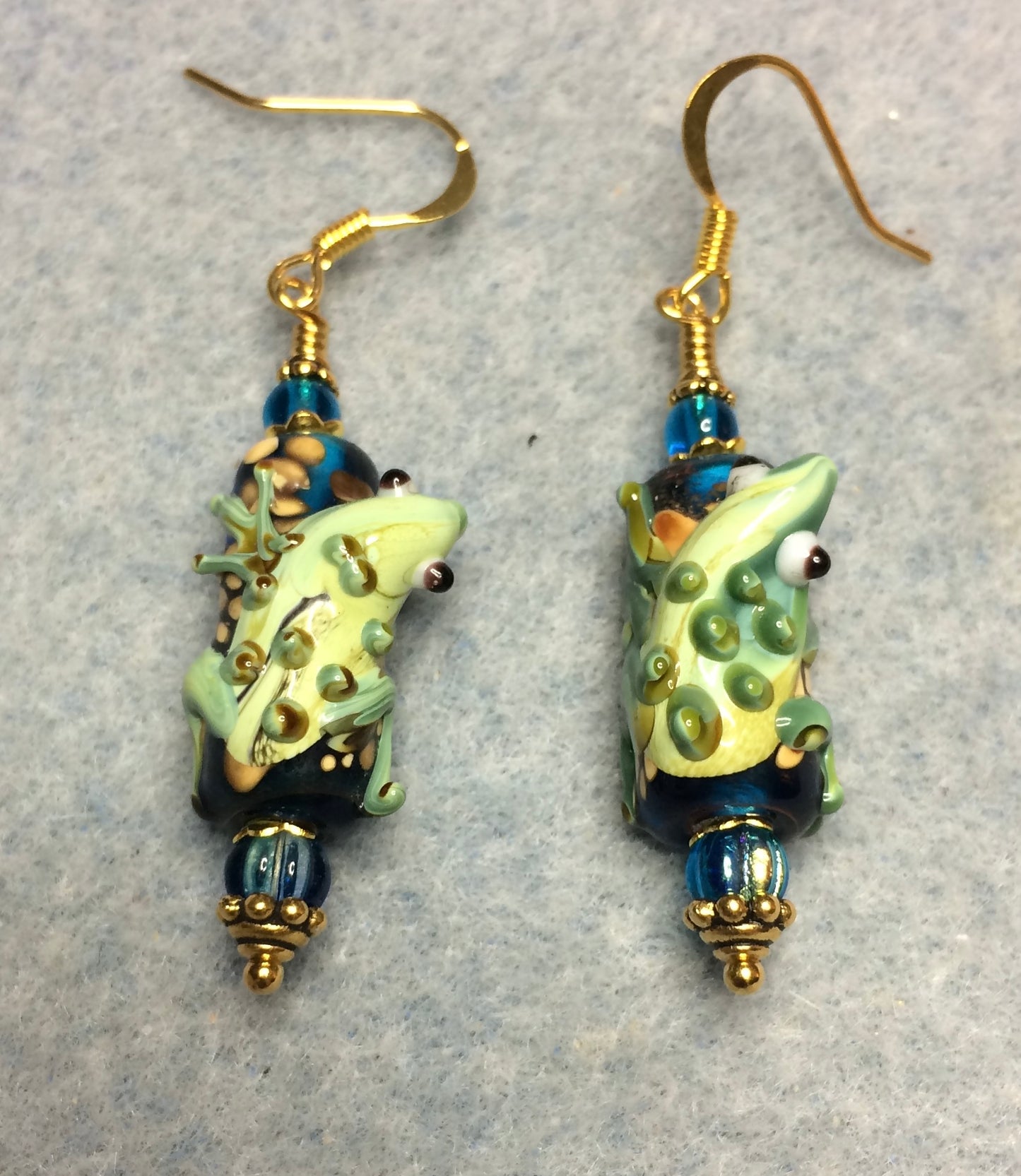 Montana blue and green lamp work lizard bead earrings adorned with Montana blue Czech glass beads.