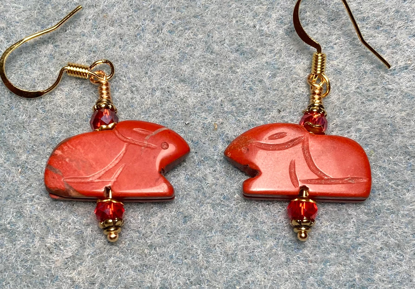 Red jasper gemstone Zuni rabbit bead earrings adorned with orange red Chinese crystal beads.