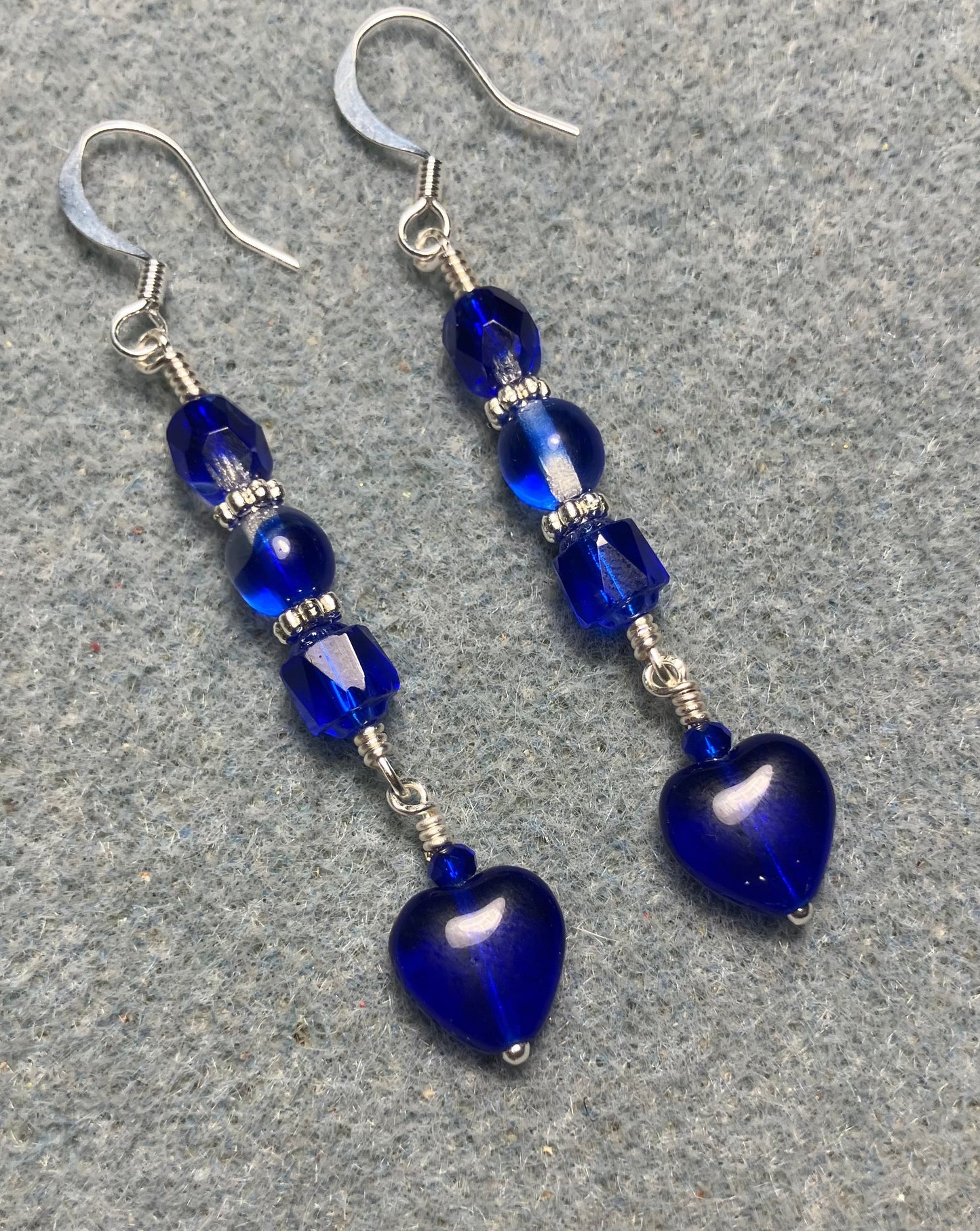 Small dark blue Czech glass heart bead earrings adorned with dark blue Czech glass beads.