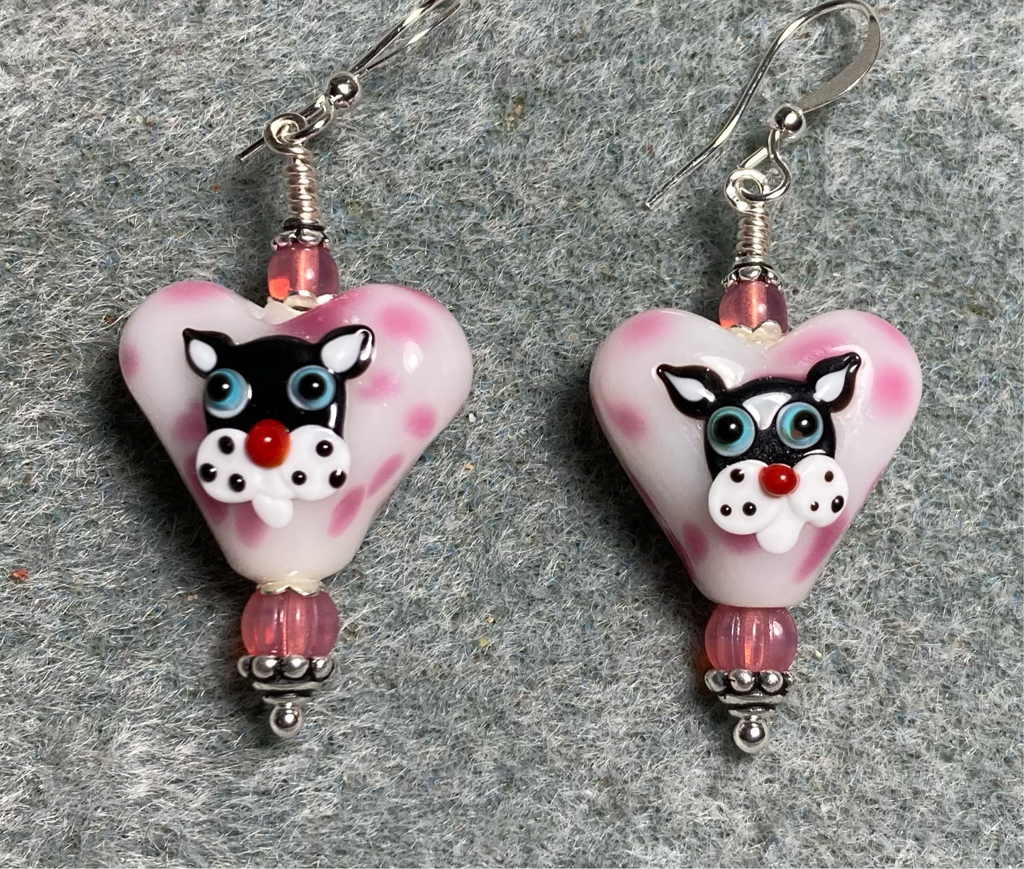 Tan and pink heart shaped lamp work cat bead earrings adorned with pink Czech glass beads.