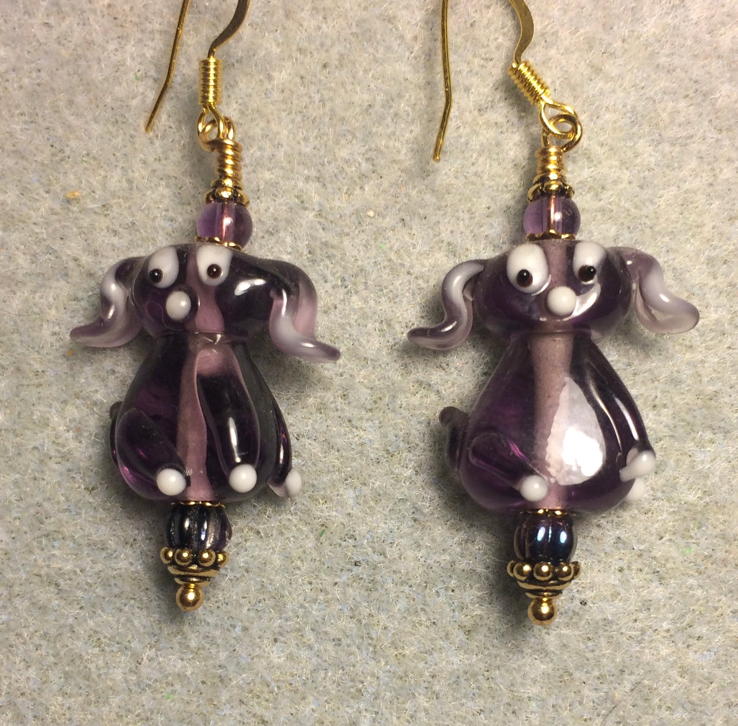 Translucent grape purple lamp work floppy eared puppy dog bead earrings adorned with grape purple Czech glass beads.