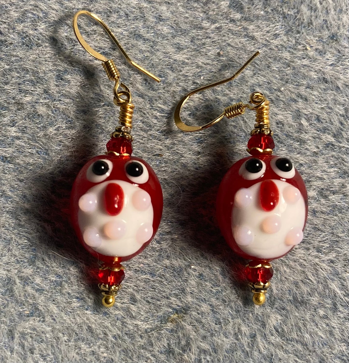 Red and white lamp work owl bead earrings adorned with dark red Chinese crystal beads.