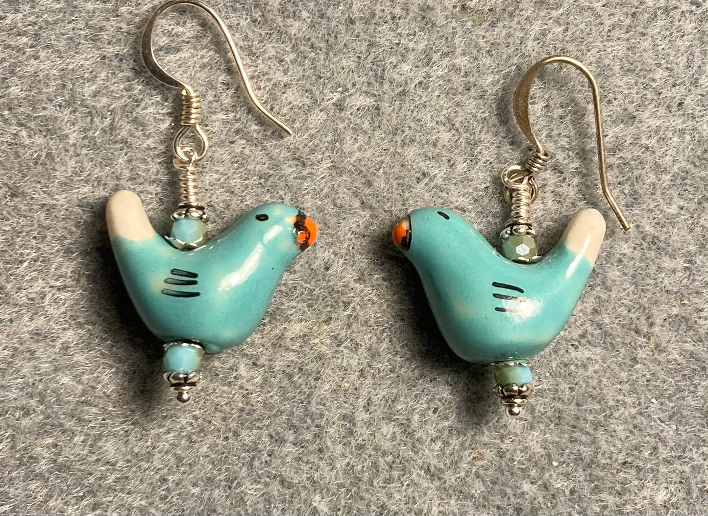 Small turquoise and white ceramic bird bead earrings adorned with turquoise Chinese crystal beads.