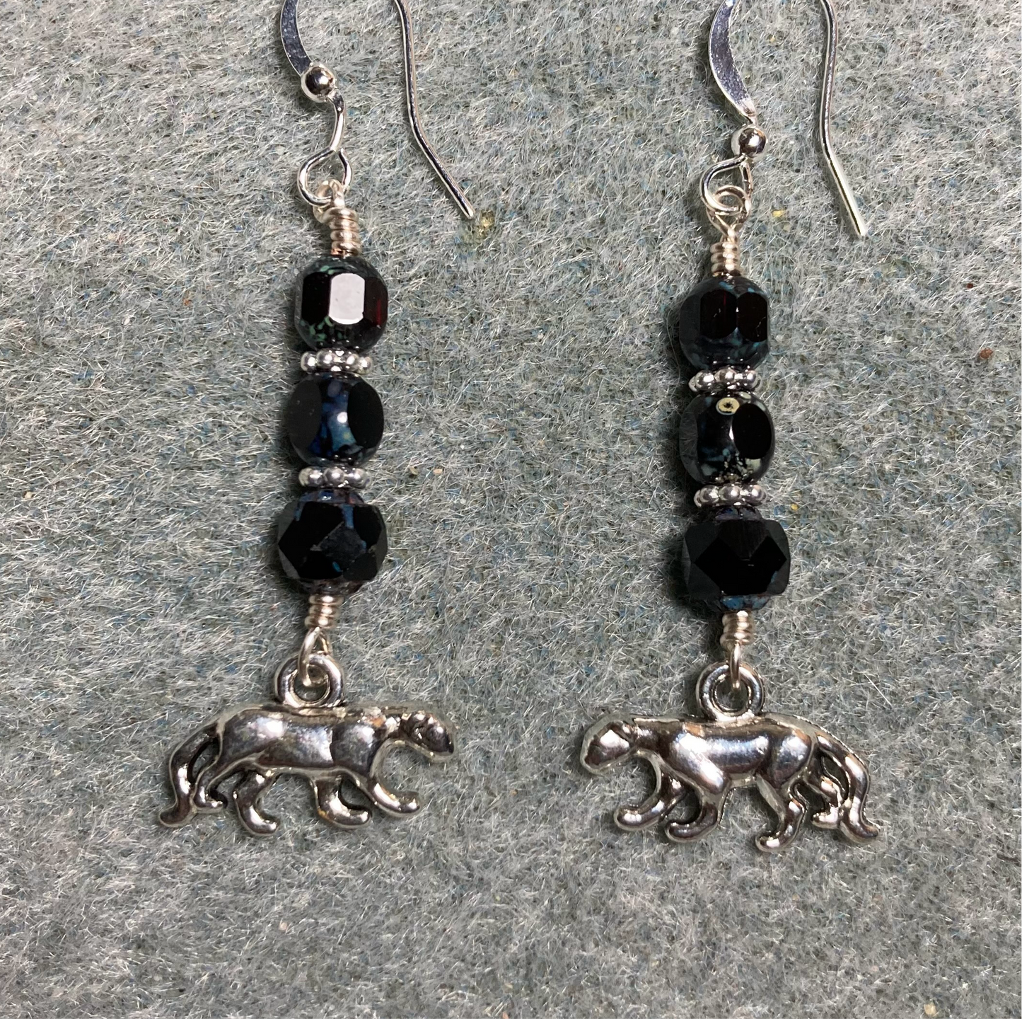 Silver panther charm earrings adorned with black Picasso Czech glass beads