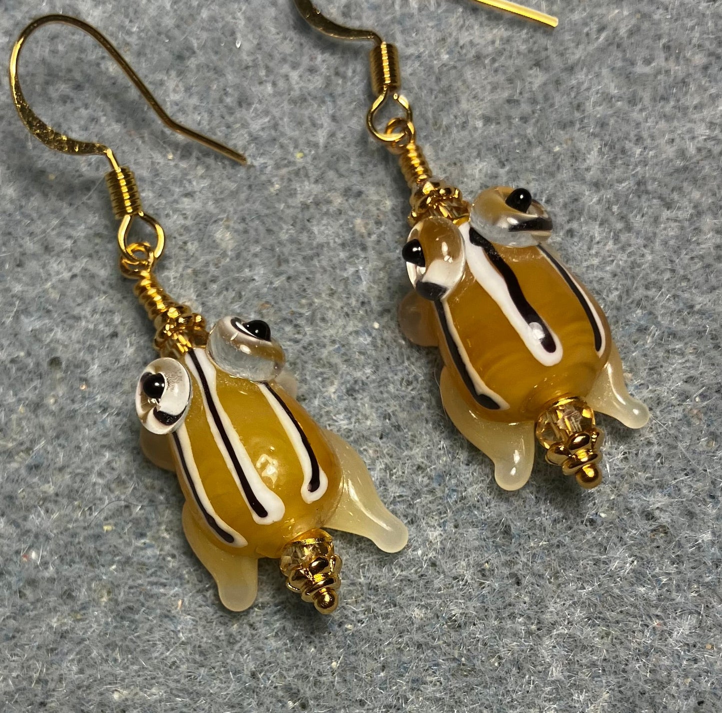 Very small golden yellow with black stripes lamp work frog bead earrings adorned with golden yellow Chinese crystal beads.