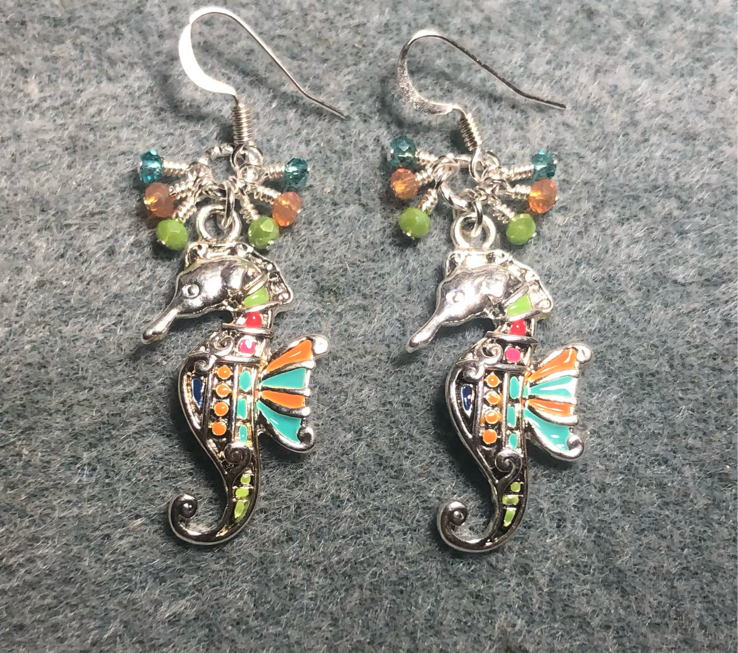 Turquoise, orange, and green enamel seahorse charm earrings adorned with small dangling turquoise, orange, and green Chinese crystal beads.