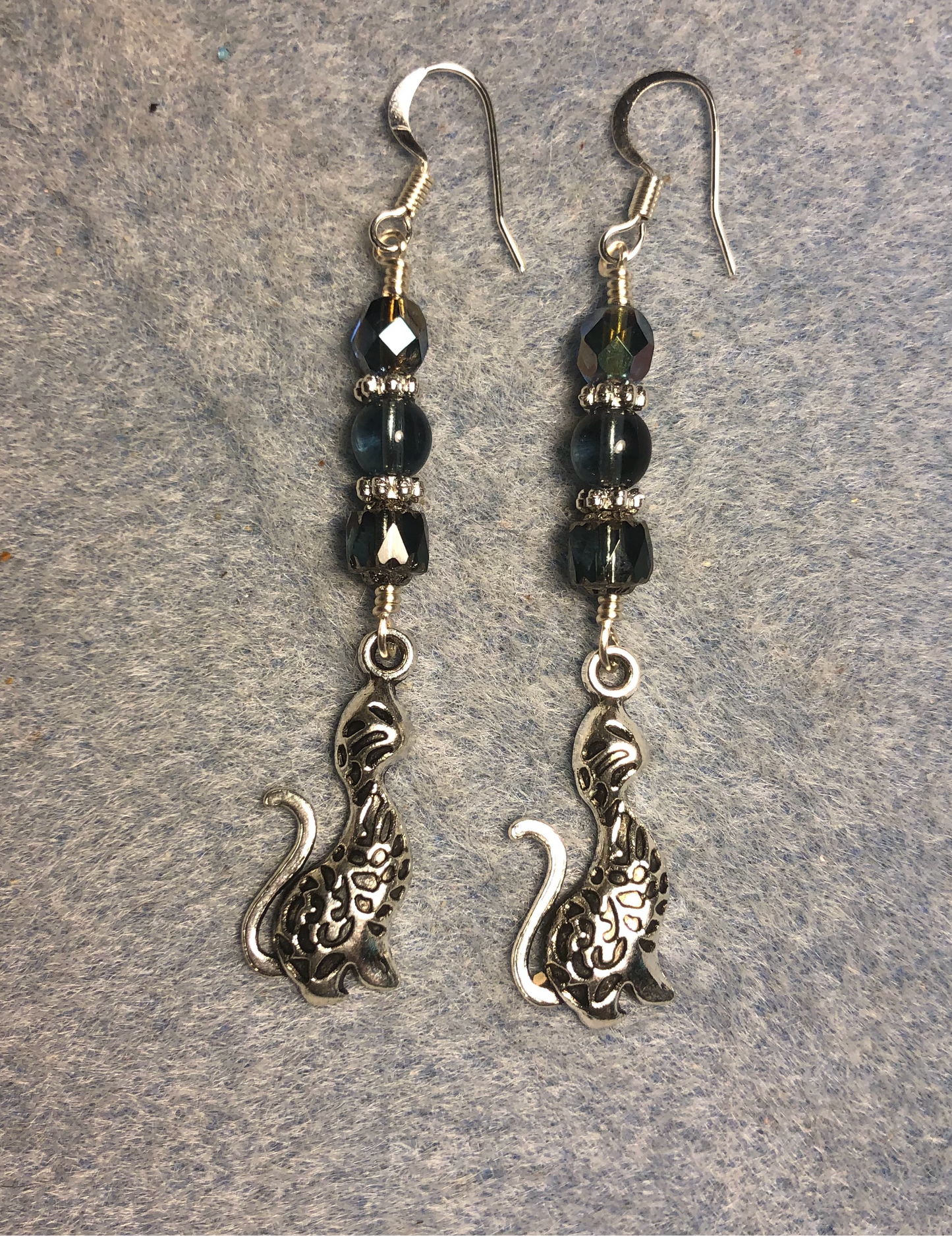 Long silver cat charm earrings adorned with Montana blue Czech glass beads