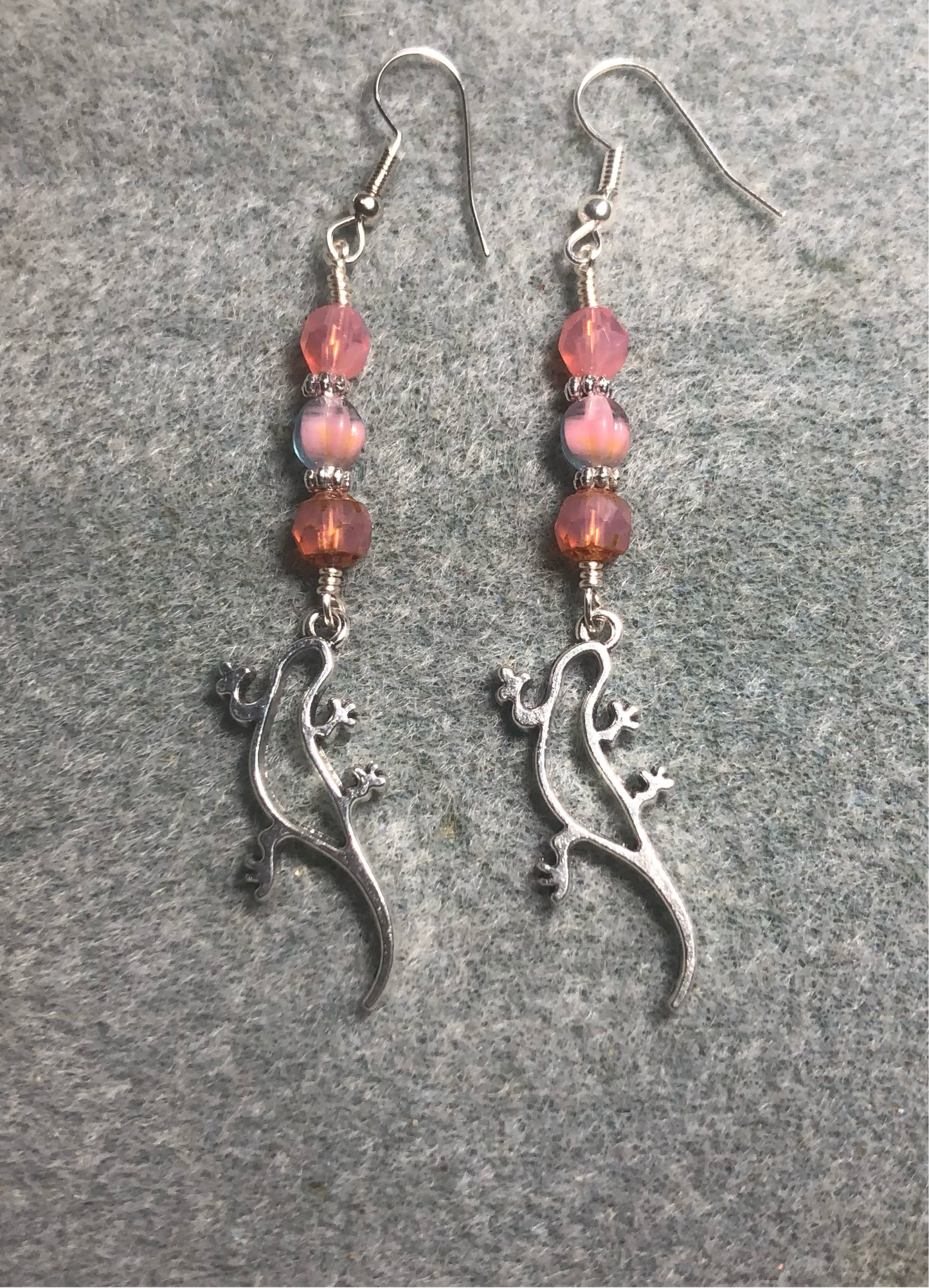 Silver lizard charm earrings adorned with pink Czech glass beads.