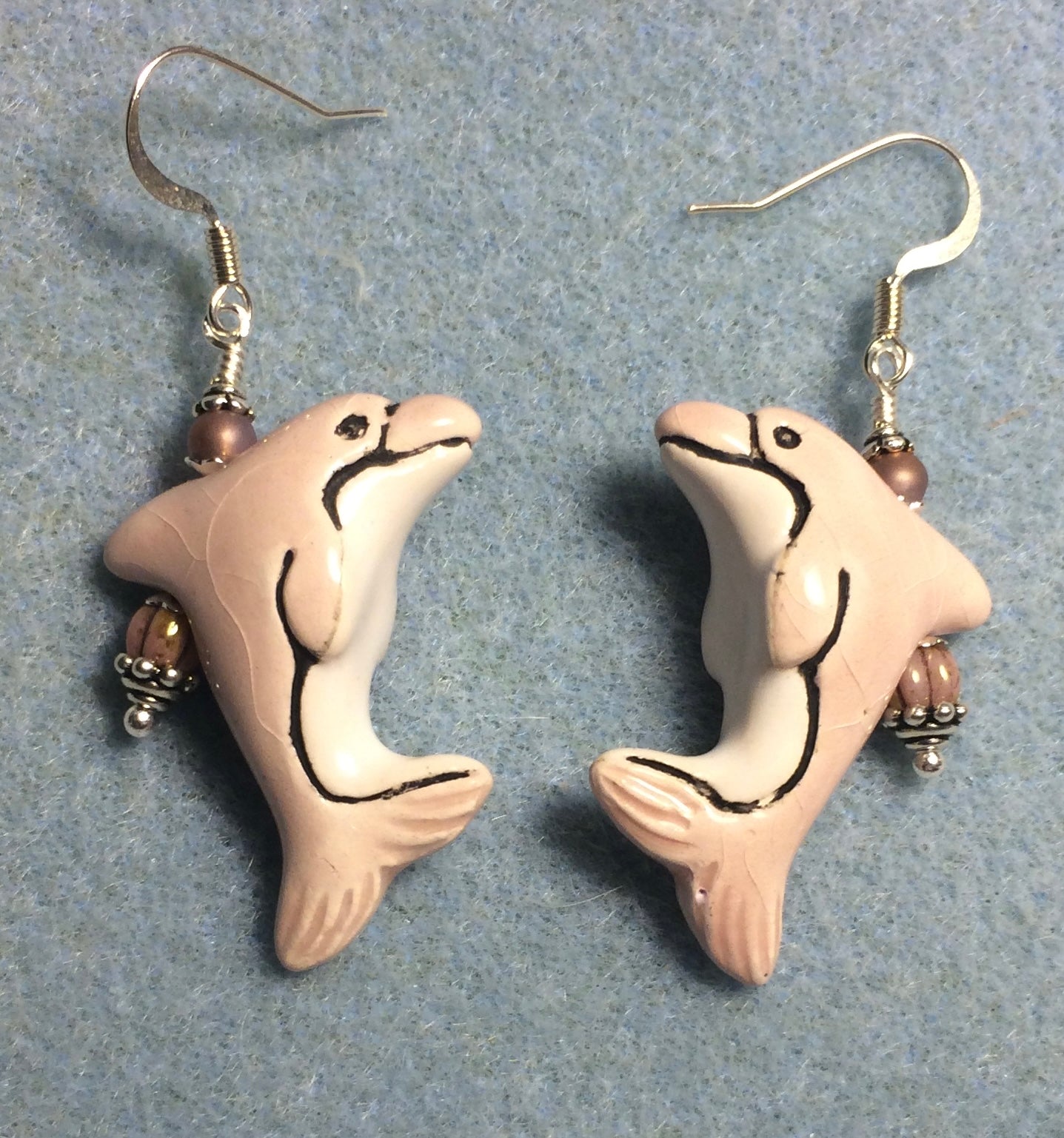 Pink and white ceramic dolphin bead earrings adorned with pink Czech glass beads.