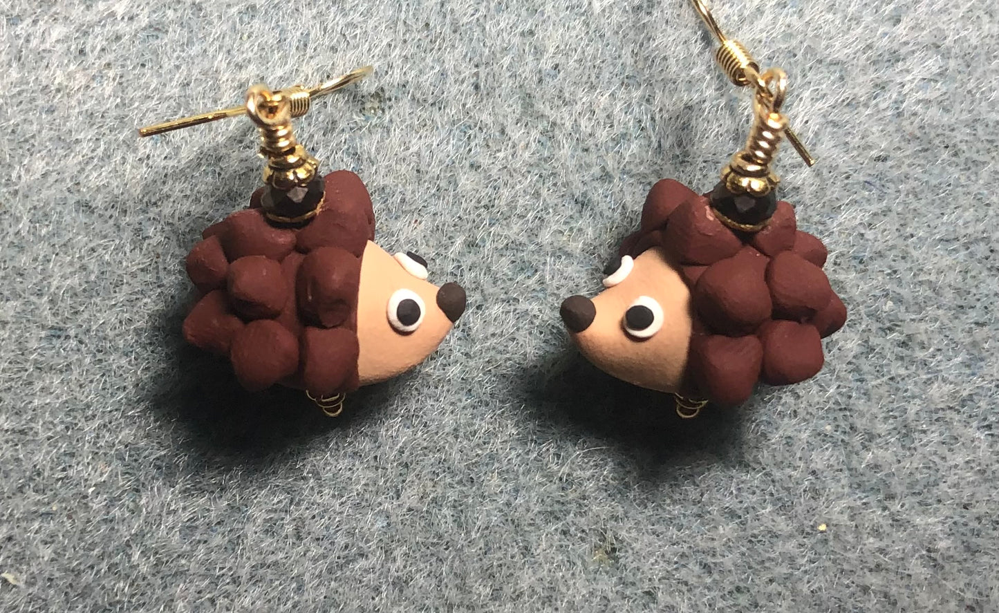 Brown and tan polymer clay hedgehog bead earrings adorned with brown Chinese crystal beads.
