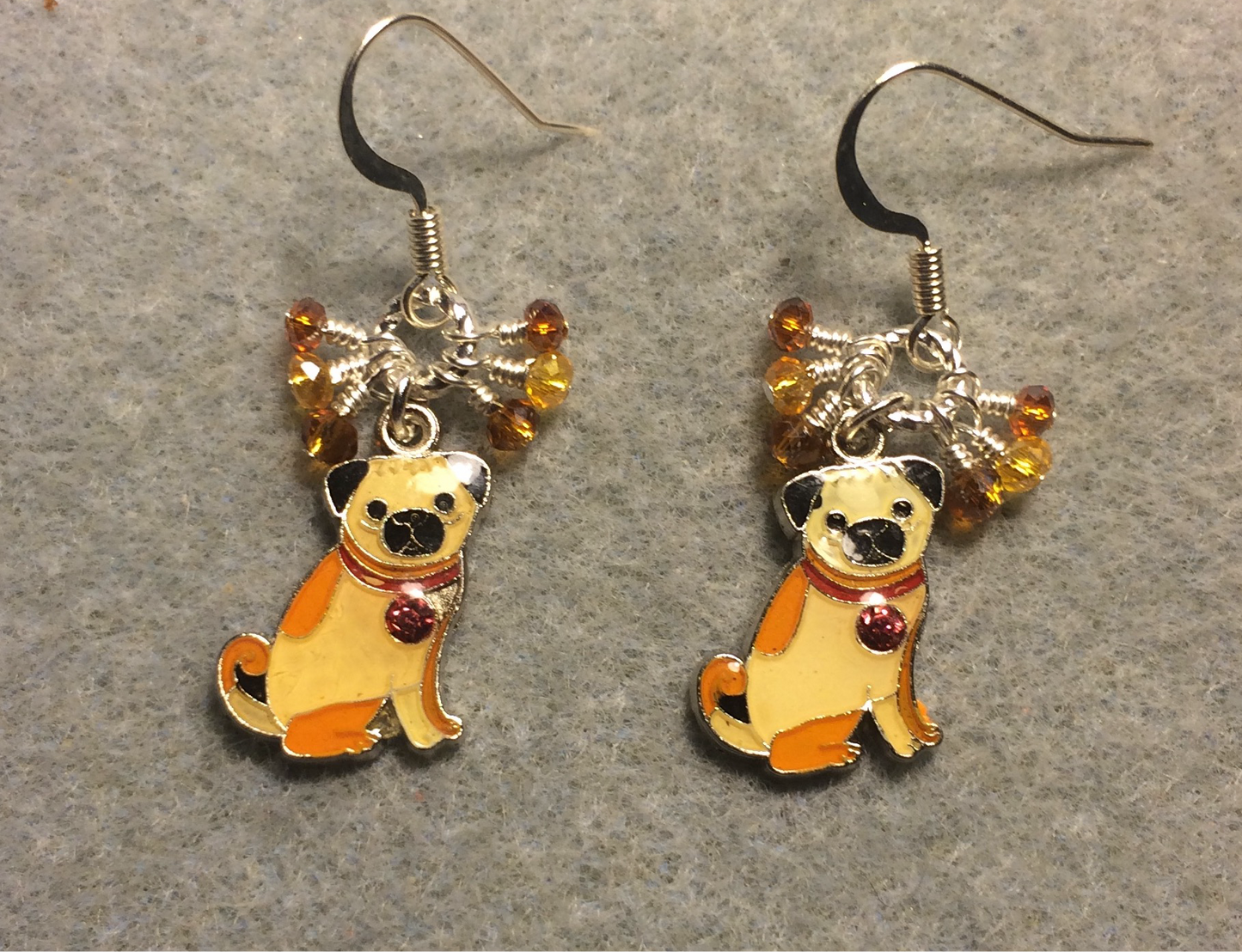 Small tan and amber enamel pug charm earrings adorned with tiny dangling tan and amber Chinese crystal beads.