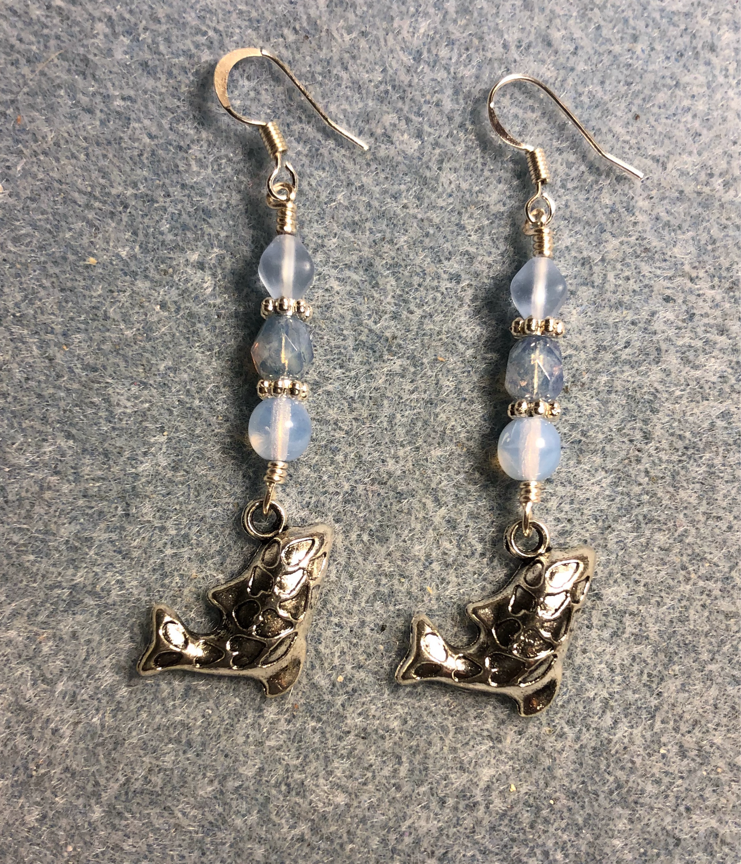 Silver whale charm earrings adorned with light blue Czech glass beads
