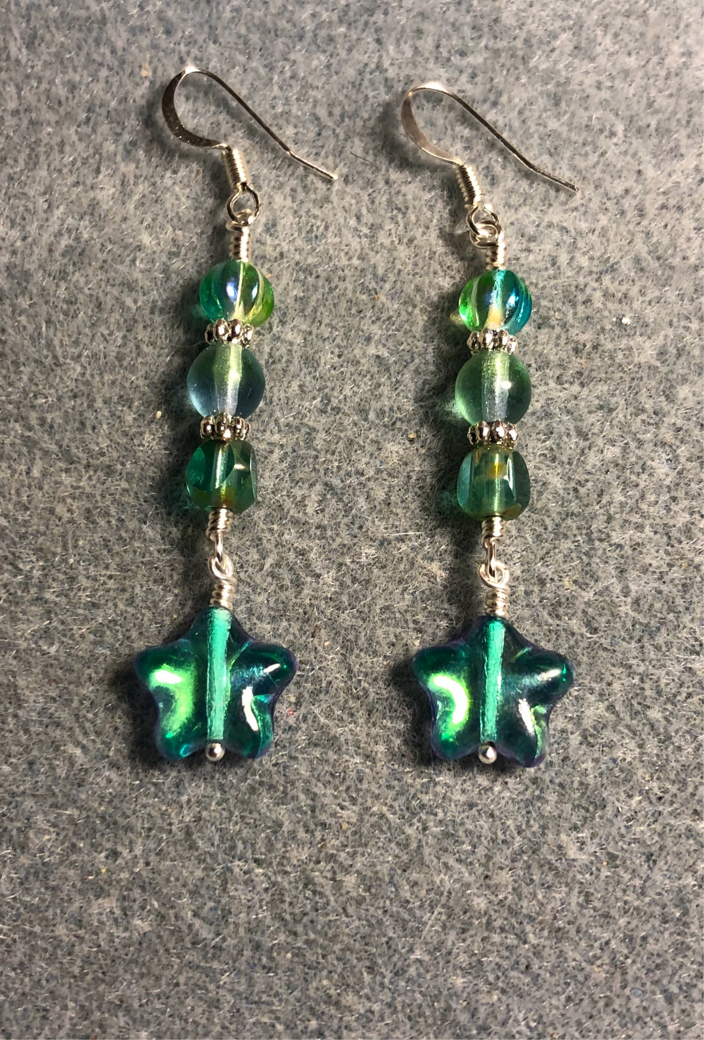 Small metallic blue green Czech glass star bead earrings adorned with blue green Czech glass beads.