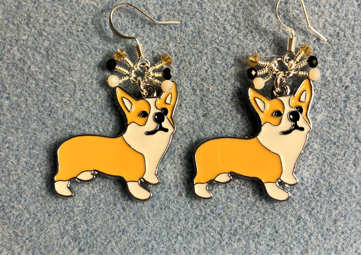 White, black, and tan enamel corgi charm earrings adorned with tiny dangling white, black, and tan Chinese crystal beads.