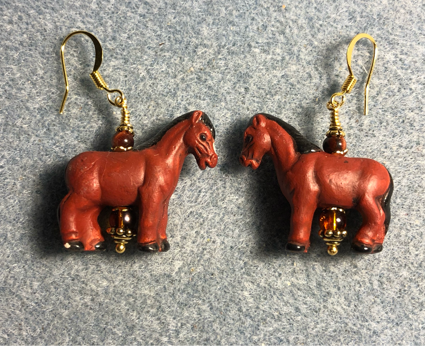 Large reddish brown ceramic horse bead earrings adorned with brown Czech glass beads.