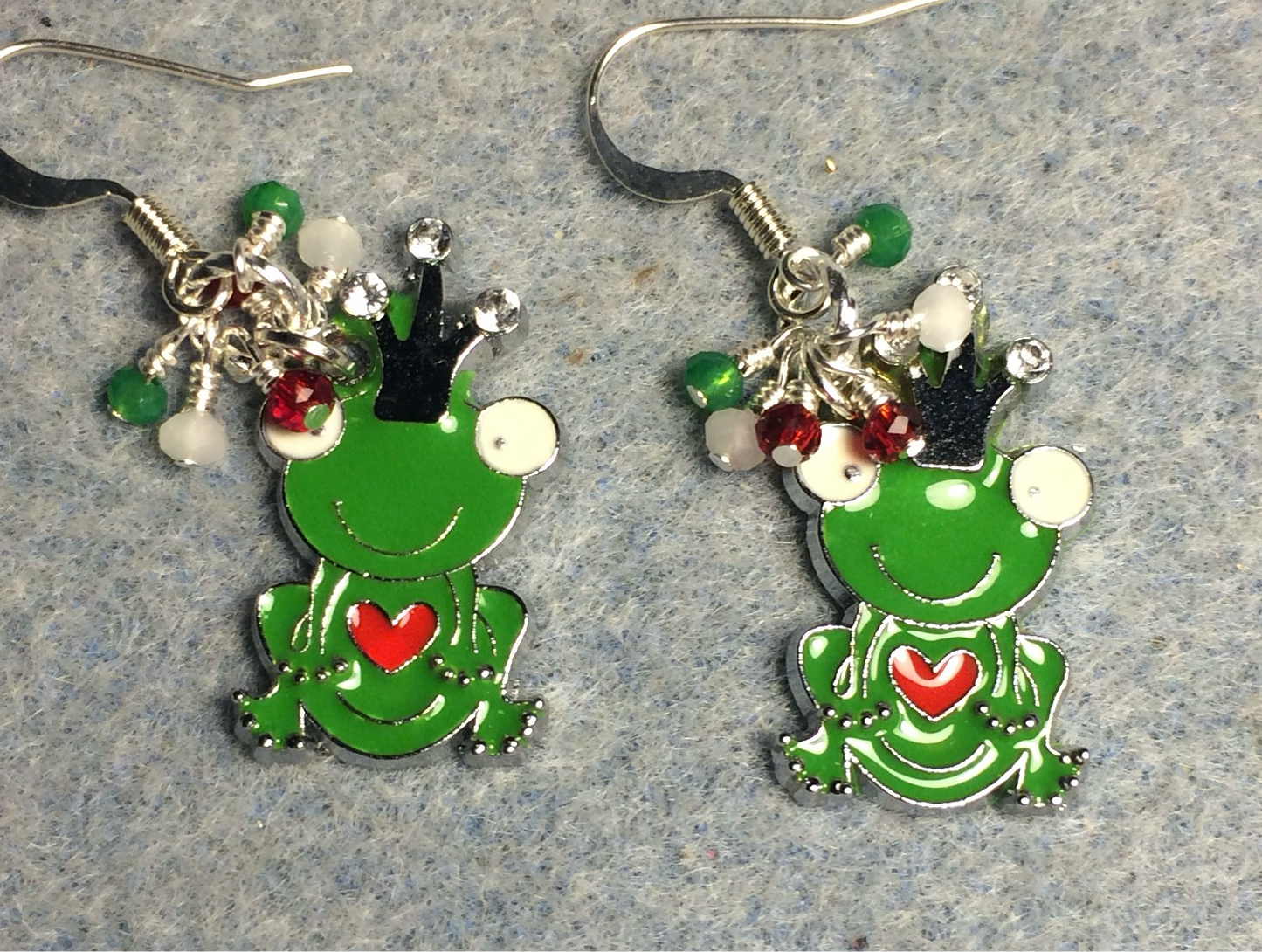 Green, white, and red enamel frog prince charm earrings adorned with tiny dangling green, white, and red Chinese crystal beads.