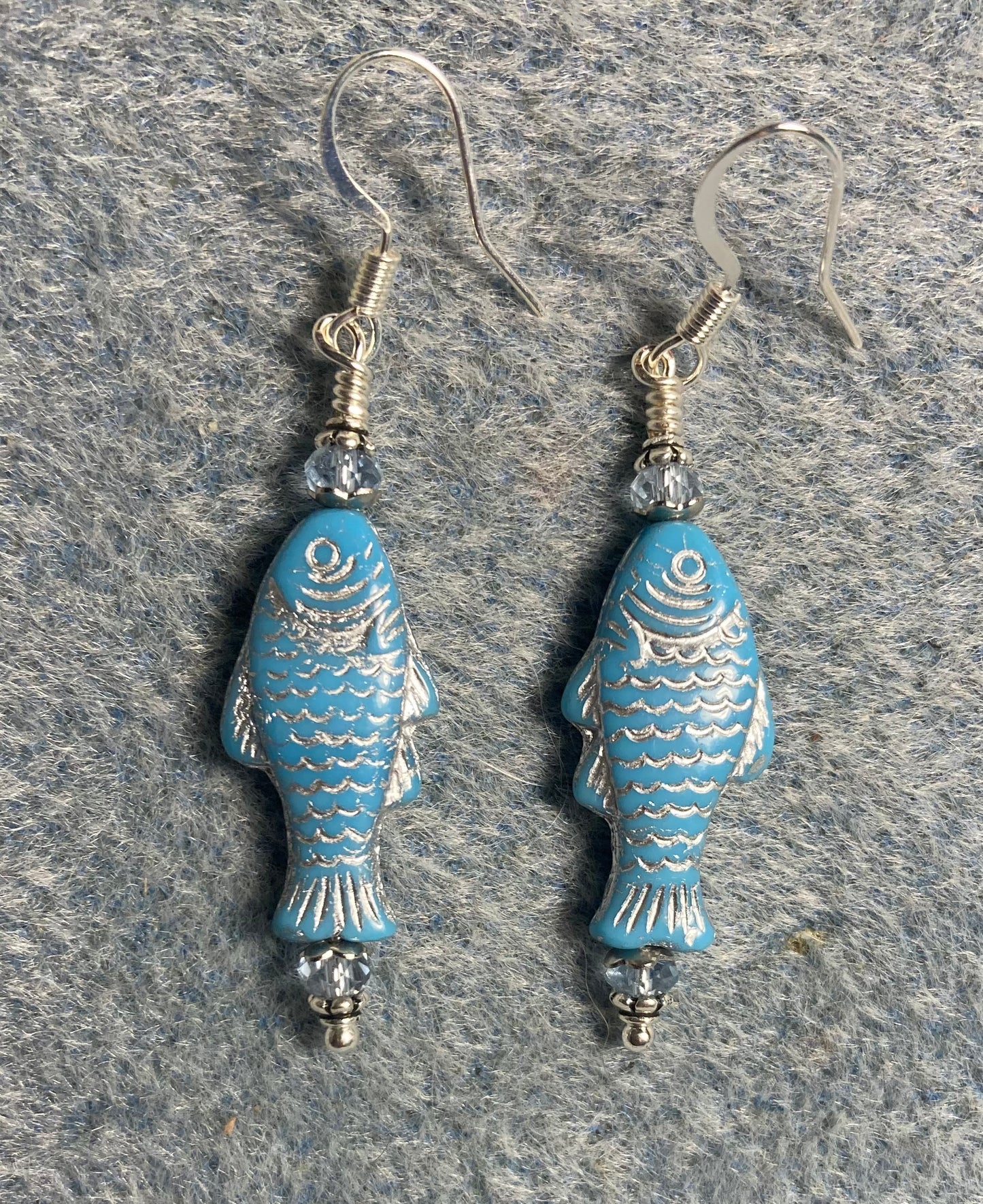 Light blue (with silver inlay) Czech glass fish bead earrings adorned with light blue Chinese crystal beads.