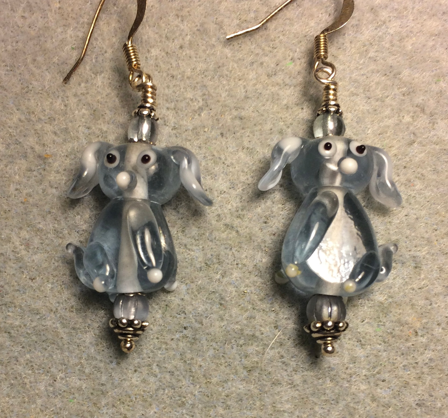 Translucent light blue lamp work floppy eared puppy dog bead earrings adorned with light blue Czech glass beads.