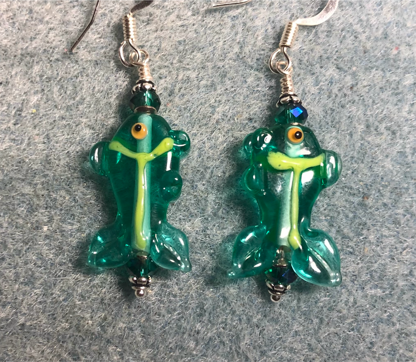 Small teal and yellow lamp work fish bead earrings adorned with teal Chinese crystal beads.