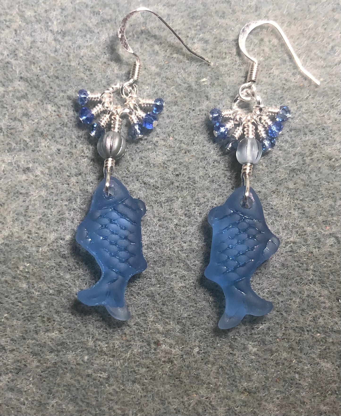 Light blue sea glass fish pendant bead earrings adorned with light blue Czech glass beads and tiny dangling light blue Chinese crystal beads.