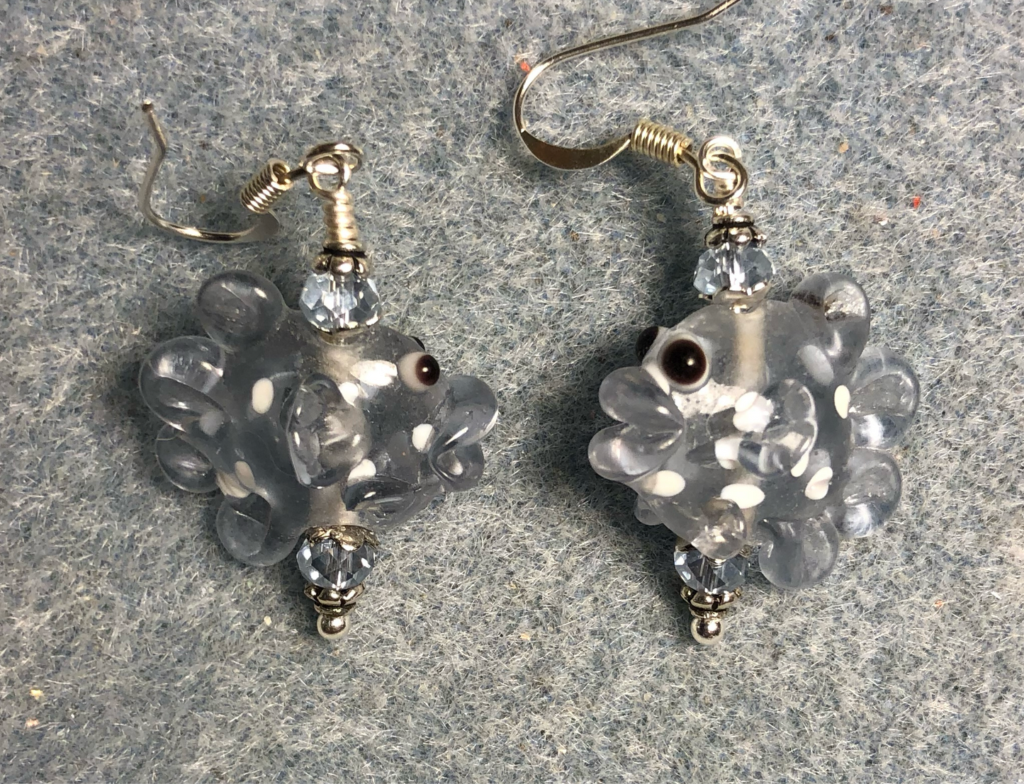 Light blue and white lamp work spotted fish bead earrings adorned with light blue Chinese crystal beads.