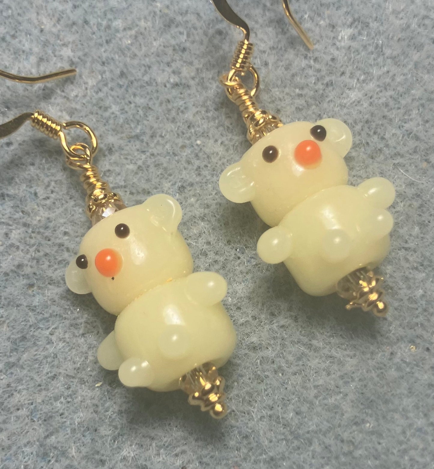 Small light yellow lamp work teddy bear bead earrings adorned with light yellow Chinese crystal beads.