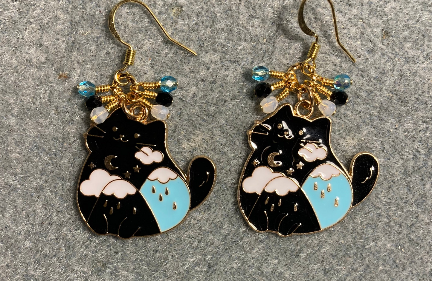 Black, white, and turquoise enamel cat charm earrings adorned with tiny dangling black, white, and turquoise Czech glass beads.